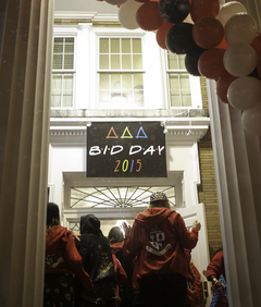 Sisters file into the Delta Delta Delta house on Walnut Place. 