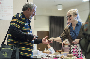 Pete Hammer, a Syracuse resident, buys a treat for the fundraising event from Willow Falkner, a sophomore international relations major. Bake sale items included brownies, muffins and cookies. 