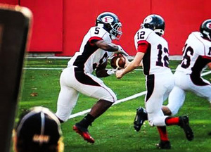 Tyrone Perkins takes a handoff for Friends Academy, where he scored 24 touchdowns last season. Perkins was the first player to verbally commit to Syracuse's Class of 2015.