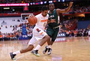 Forward Michael Gbinije, who head coach Jim Boeheim later said is not an effective player for SU right now, looks to attack the basket Tuesday night.