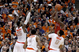 St. John's guard Phil Greene IV elevates for a shot above Rakeem Christmas. Greene  had 13 second-half points, helping the Red Storm pull away late.