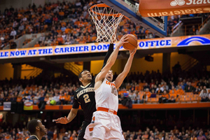 Trevor Cooney rises for a layup in the first half while being defended by Devin Thomas. The SU junior guard continued his hot streak, finishing with 21 points on 6-of-17 shooting.