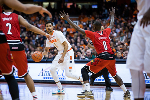 Michael Gbinije looks to make a play amid a packed Louisville defense. He finished with 18 points and made strong defensive plays in the upset win. 