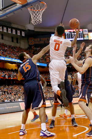 Michael Gbinije attacks the rim against UVA's Malcolm Brogdon. Gbinije scored just eight points in 40 minutes, making just two field goals while shooting 1-of-6 from 3.