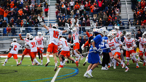 Brendan Curry jumps to celebrate with his teammates after the game-winning goal.