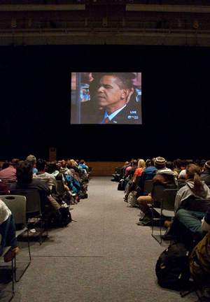 Barack Obama takes the oath of office as a crowd of 700 people watch from Goldstein Auditorium in the Schine Student Center.