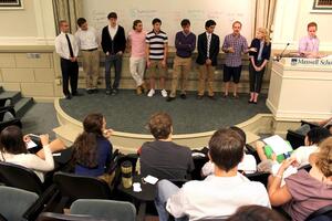 Colin Brown, second from right on stage, a sophomore broadcast and digital journalism major, speaks to the Student Assocation general assembly on Monday in Maxwell Auditorium. Brown was elected to represent the S.I Newhouse School of Public Communications.