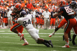 Syracuse running back Prince-Tyson Gulley breaks away from defender Ibraheim Campbell on his way to the end zone in the first half.