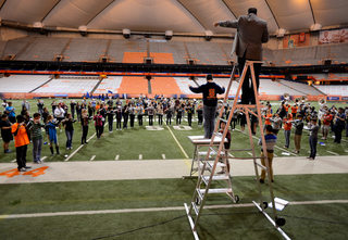 Professor Justin Mertz, SU Marching Band director and assistant director of bands, leads students through a Led Zeppelin routine.