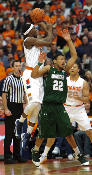 Syracuse forward C.J. Fair shoots over Wagner guard Dwaun Anderson.