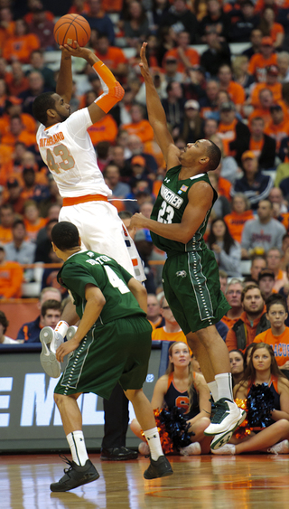 Syracuse forward James Southerland rises over Jonathon Williams for a jumper.