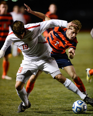 Syracuse's Louis Clark (7) and Cornell's Jake Rinow (19) battle for possession during their NCAA tournament game on Thursday night.