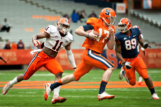 Syracuse quarterback Charley Loeb runs away from linebacker Marquis Spruill.