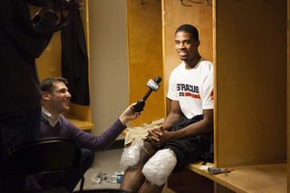 Syracuse forward C.J. Fair smiles, ice on his knees, after another Atlantic Coast Conference win for his team. 