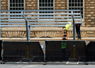 Crews work on installing a covered parking structure for Syracuse University ambulances. Work at the Quad 2 parking lot is expected to be completed in August. Photo taken Aug. 1, 2017